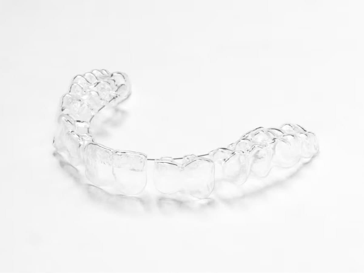 A clear Invisalign aligner tray